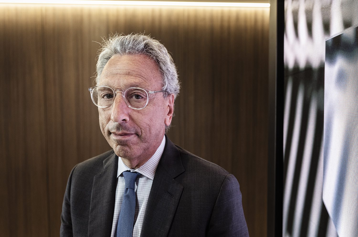 Barry Gosin in a suit and clear-framed glasses, photographed for a 2018 interview