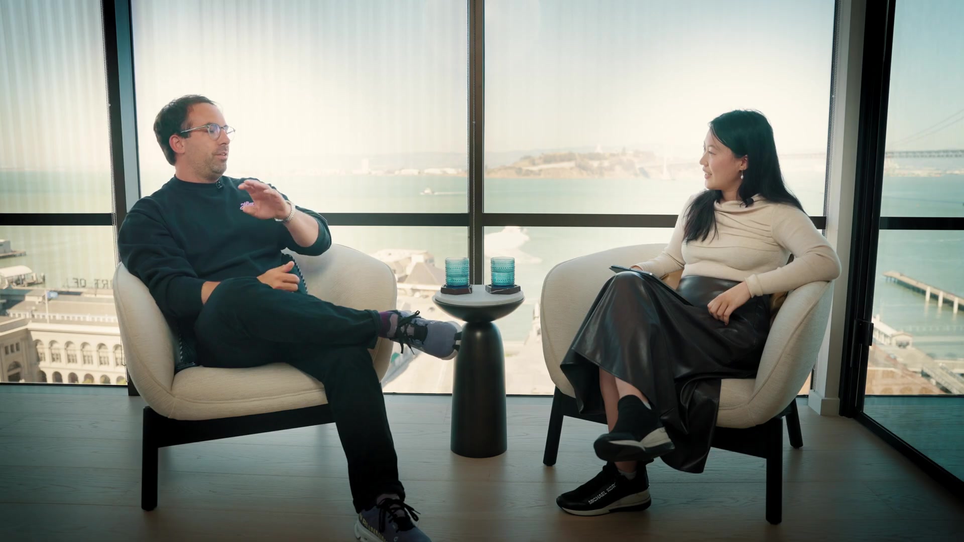 Barry McCardel speaking with Ivory Tang in armchairs overlooking San Francisco Bay