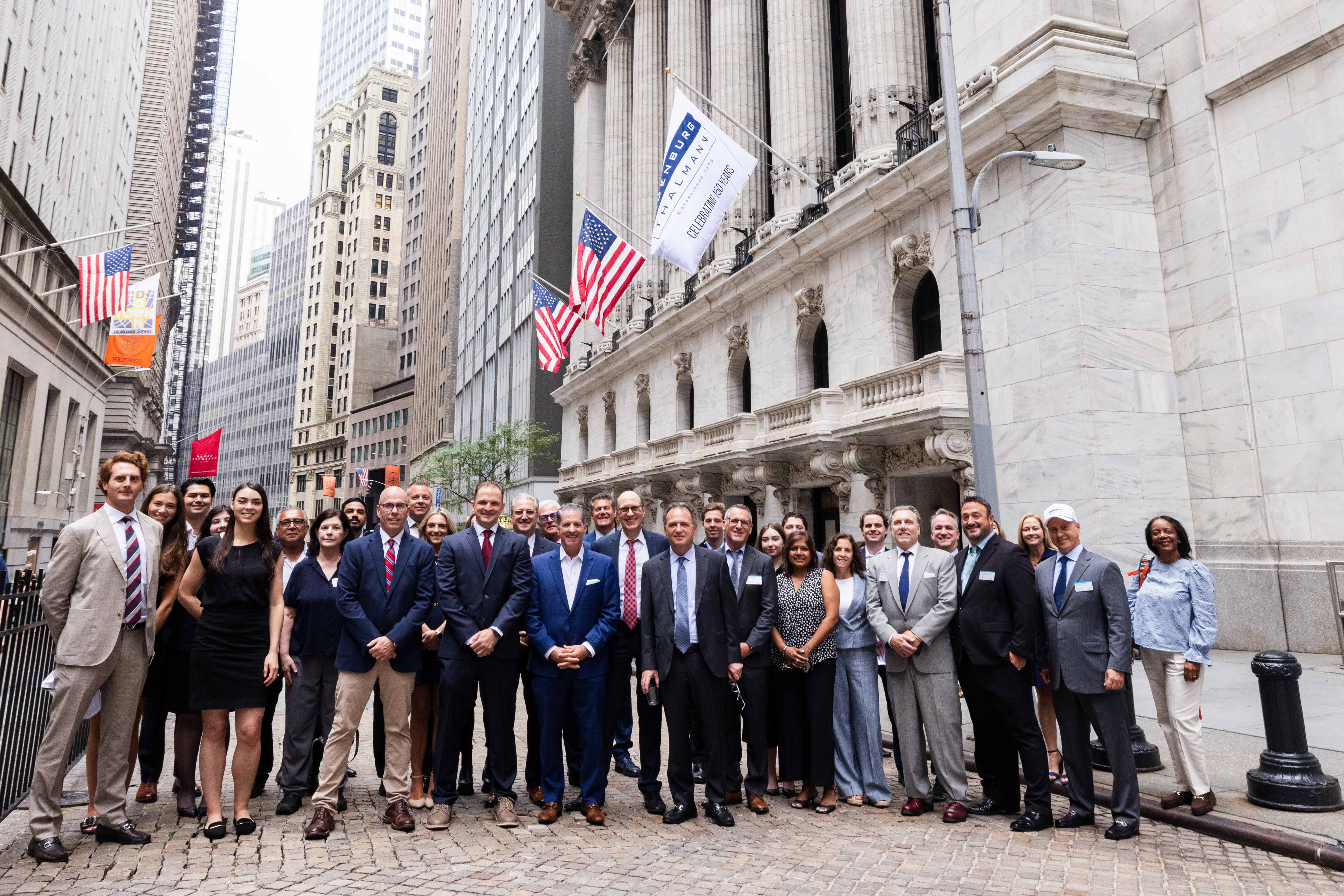 Ladenburg Thalmann colleagues and guests gathered outside the New York Stock Exchange during the firm's July 2026 anniversary celebration