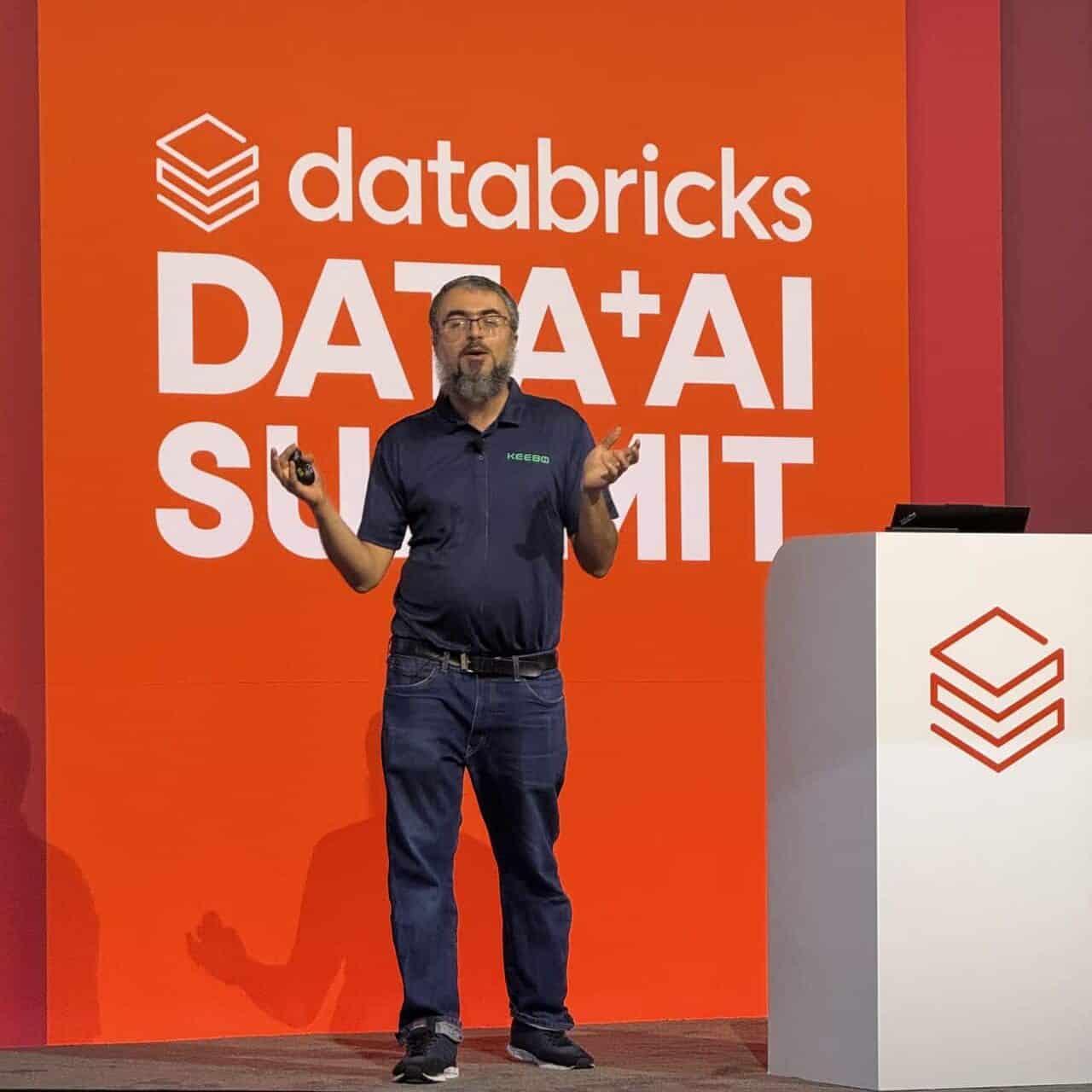 Barzan Mozafari speaking onstage at Databricks Data + AI Summit 2026