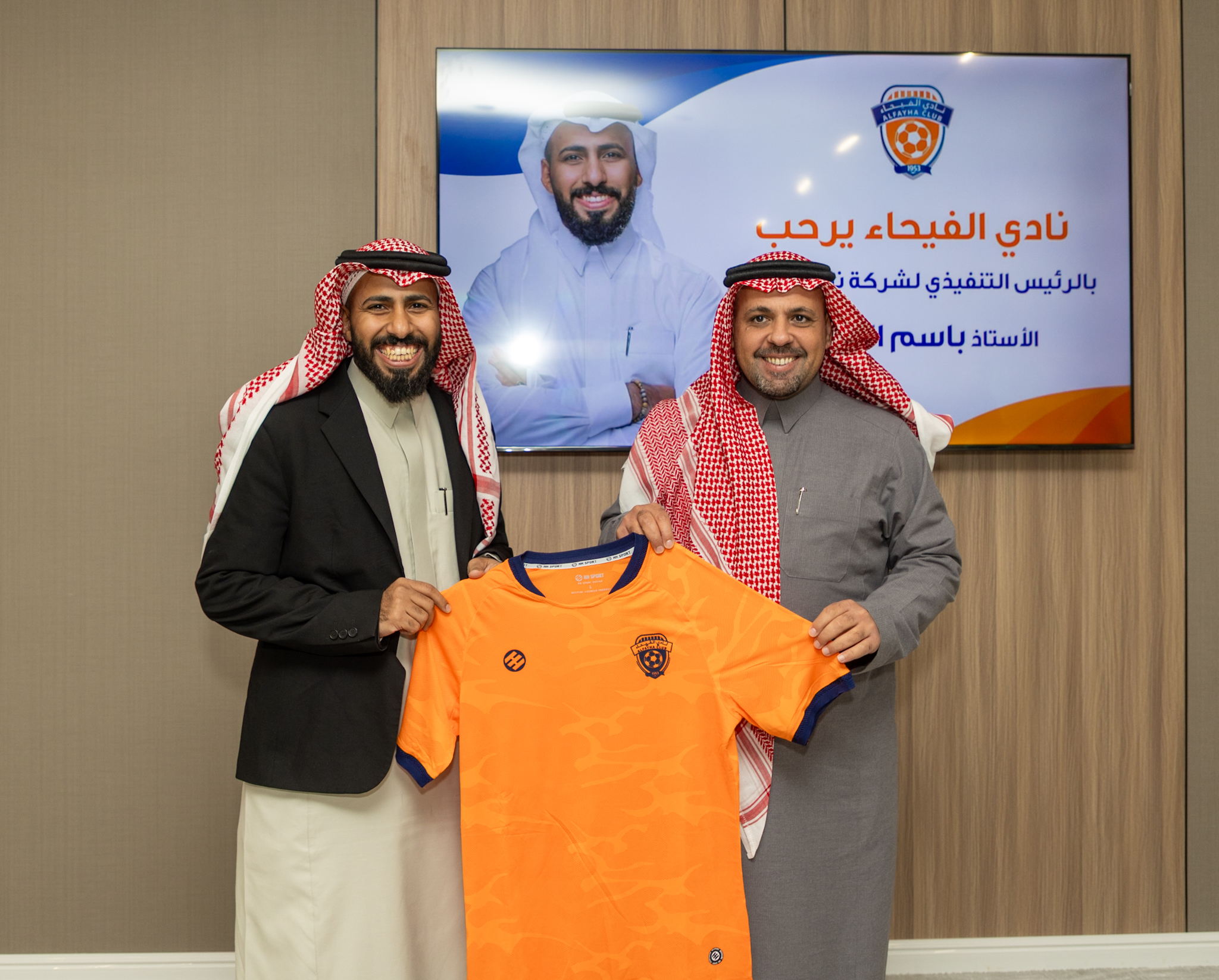Basim Albeladi, left, and Al Fayha chairman Tawfiq Al-Mudaiheem holding an orange club shirt during the January 2026 visit