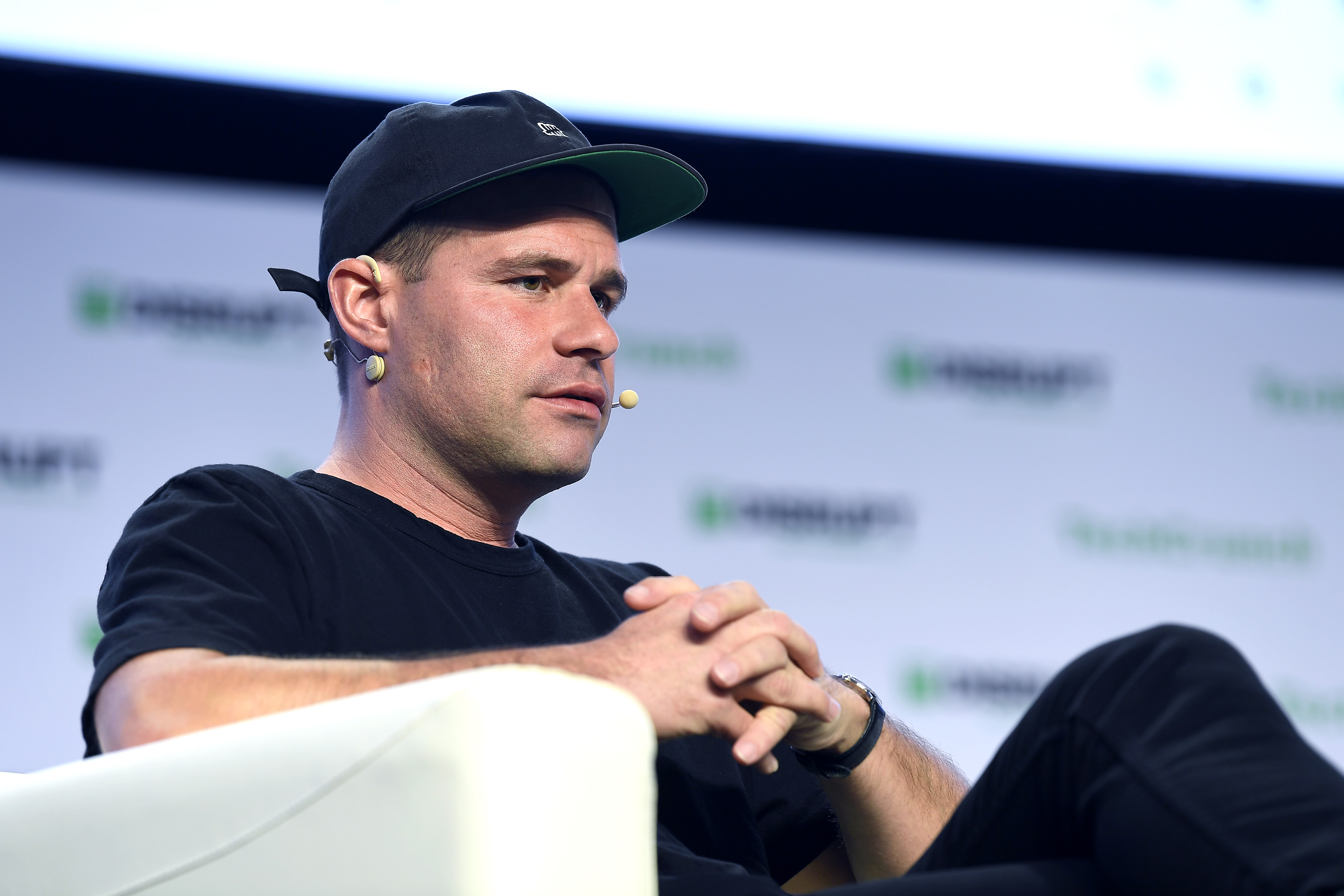 Bastian Lehmann seated onstage at TechCrunch Disrupt San Francisco in 2019, wearing a dark cap and speaking through a headset.