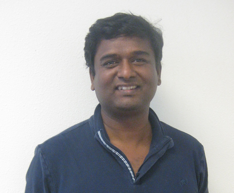 Bastin Gerald smiling in a navy shirt