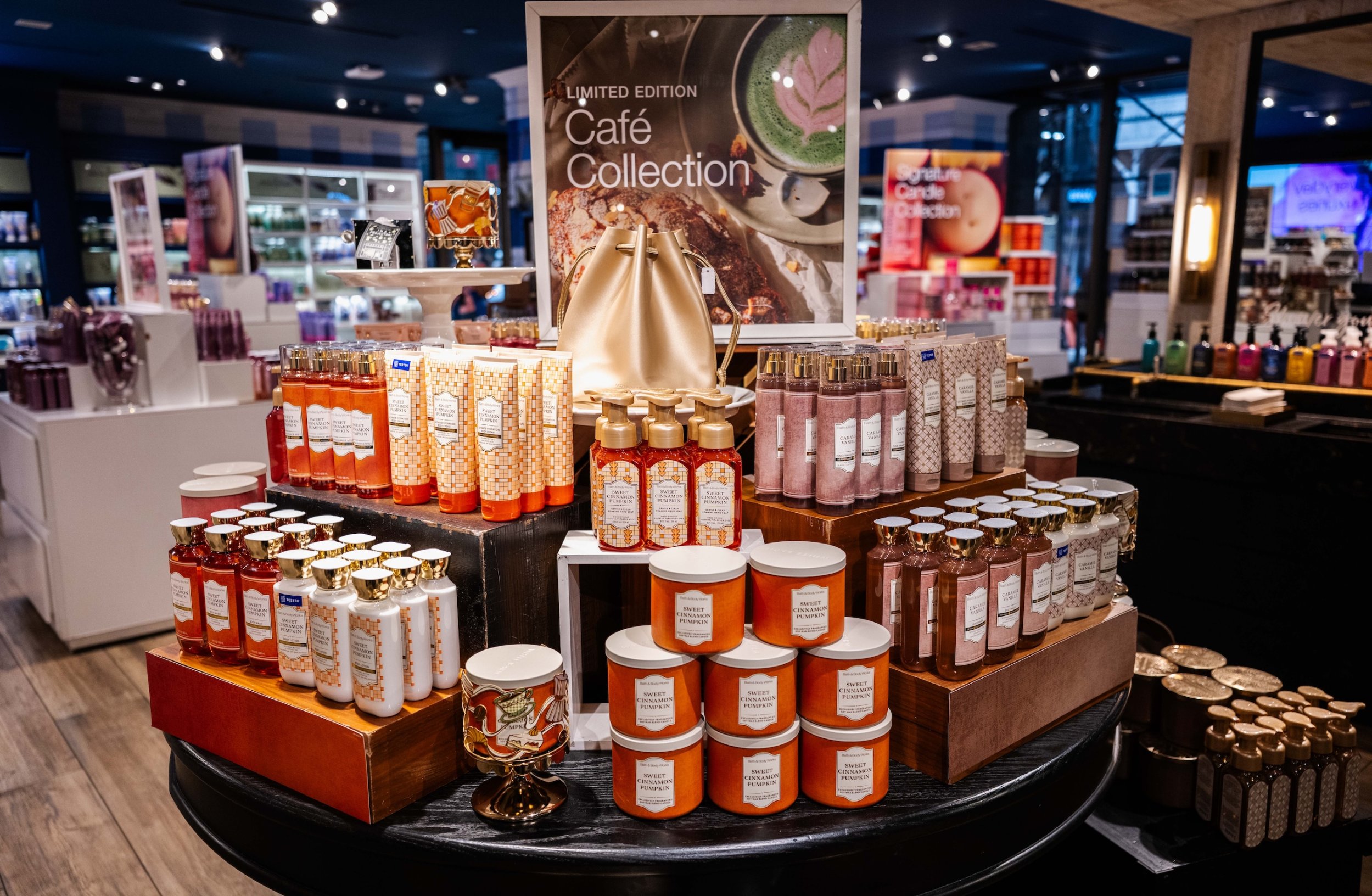 Bath & Body Works Café Collection display with creams, mists, candles and soaps