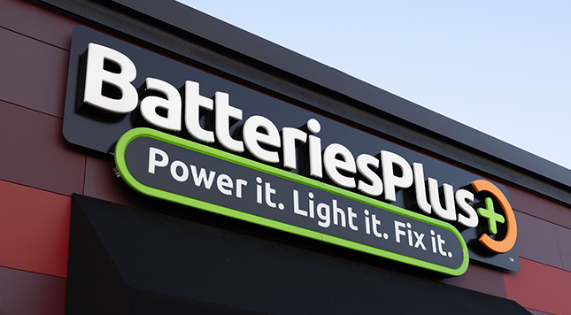 Batteries Plus storefront sign with the 2021 logo and tagline Power it. Light it. Fix it.