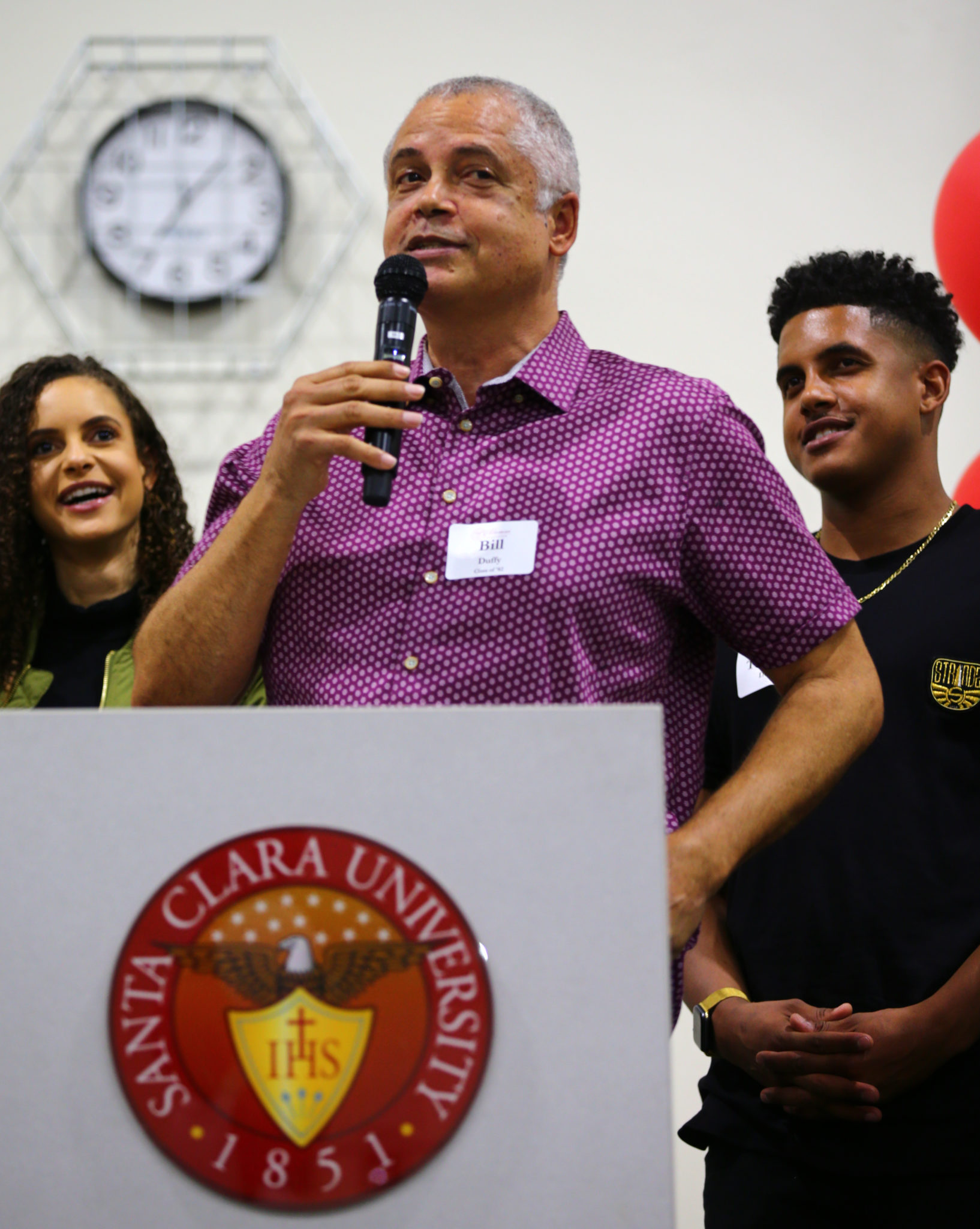 Bill Duffy speaking with young people at a community event