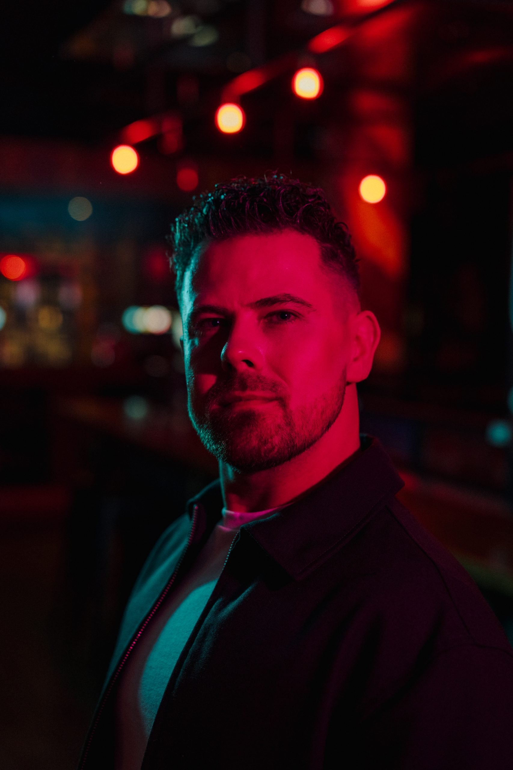 Be Broadcast founder Josh Wheeler in red and teal studio lighting