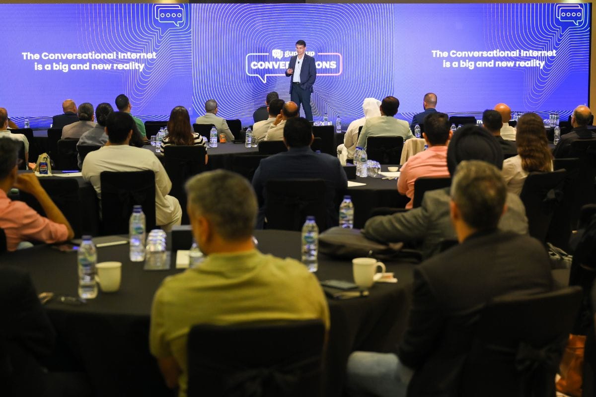 Beerud Sheth speaks onstage at a Gupshup Conversations event, facing a seated audience.
