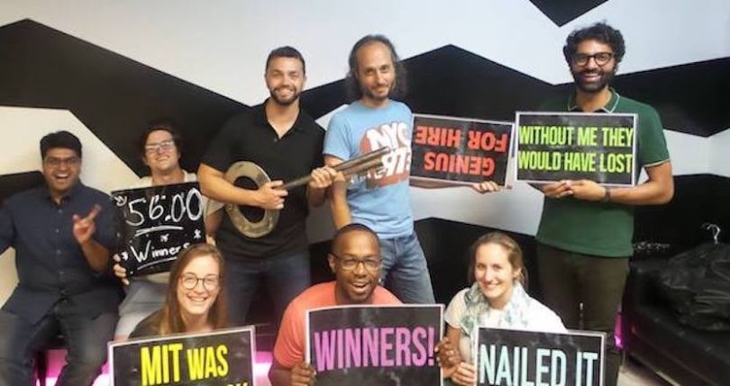 Beeswax team members holding celebratory signs in a historical company photo
