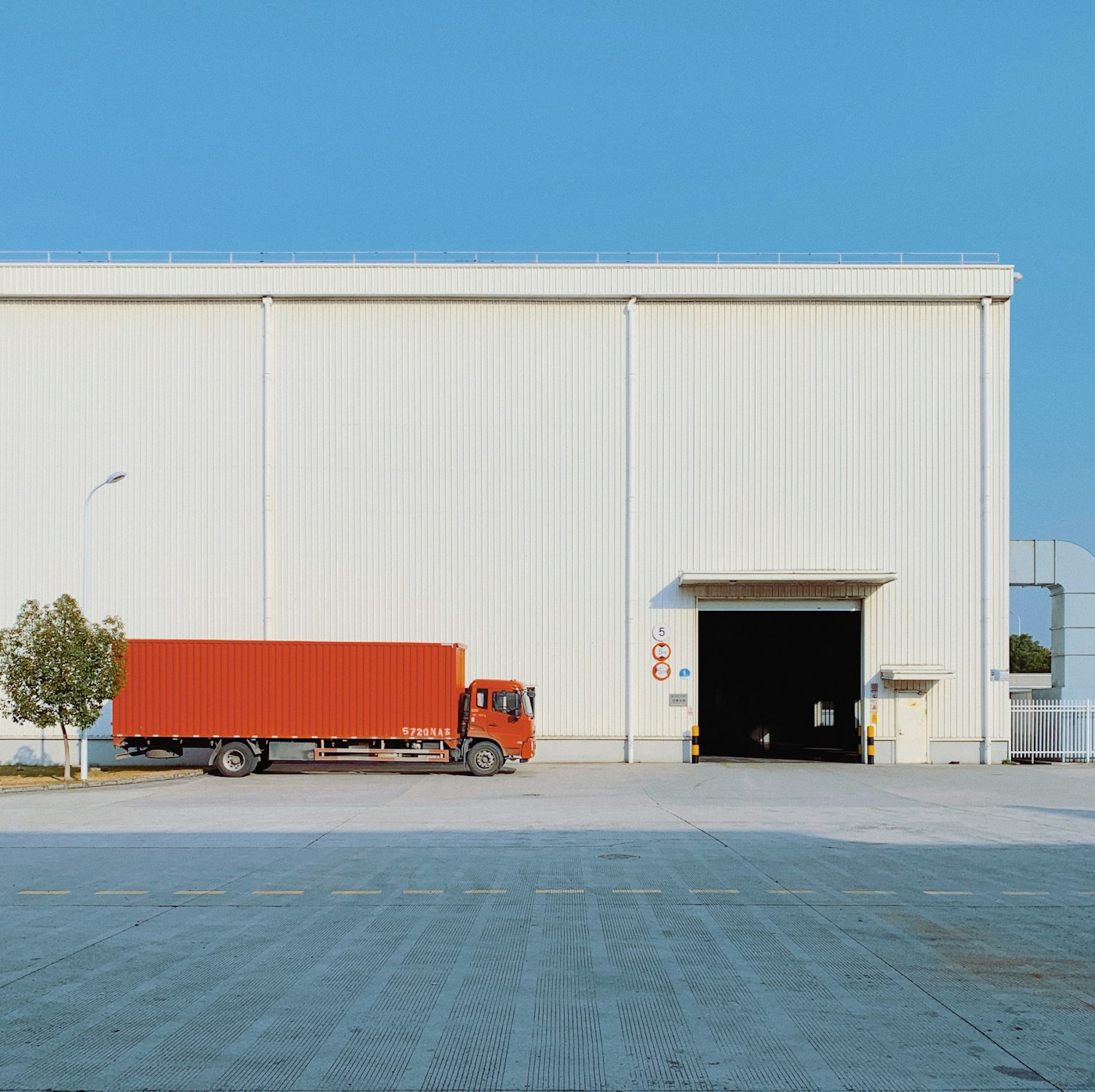 Freight truck beside a warehouse