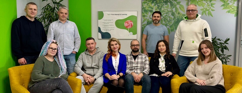 Belitsoft team members gathered around yellow sofas in an office