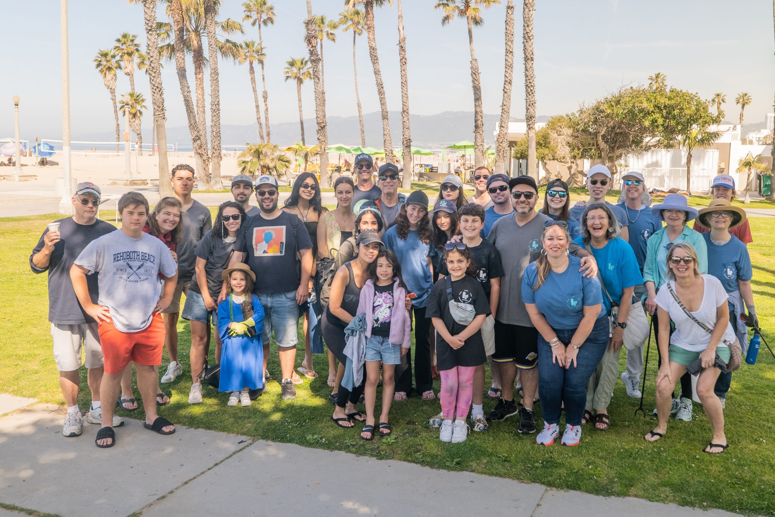 Participants gather beside the palm trees for a Branding Los Angeles Earth Day community photograph.