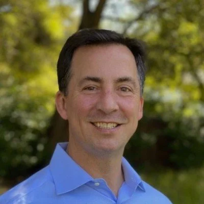 Ben Bisconti outdoors, wearing a blue shirt