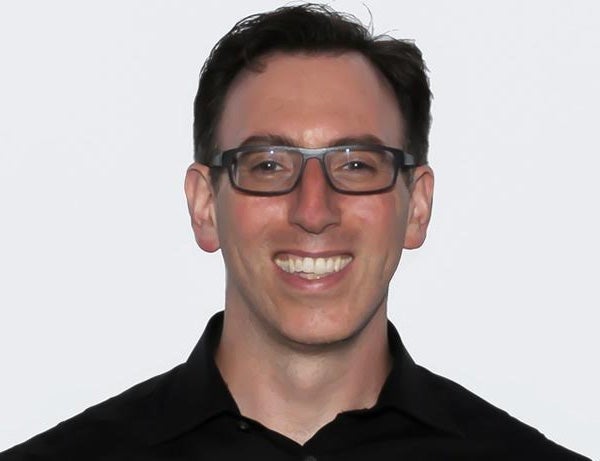 Ben Kirshner smiling in an archival Elite SEM press photograph