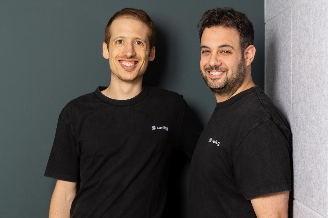 Zenity co-founders Michael Bargury and Ben Kliger standing together in black Zenity shirts