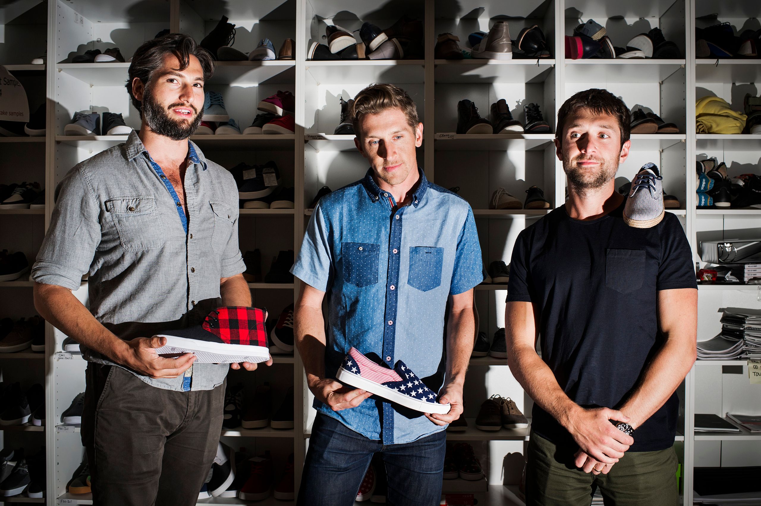 Adam Rich, Jason Ross and Ben Lerer in front of shelves of footwear at the Thrillist office