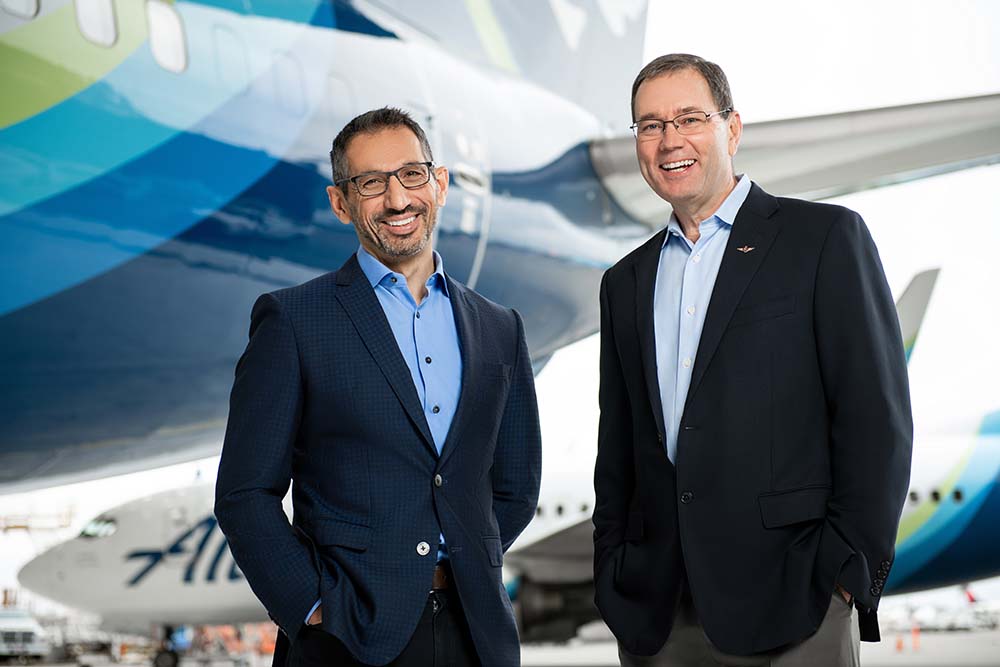 Ben Minicucci, left, standing with Brad Tilden beside an Alaska Airlines aircraft