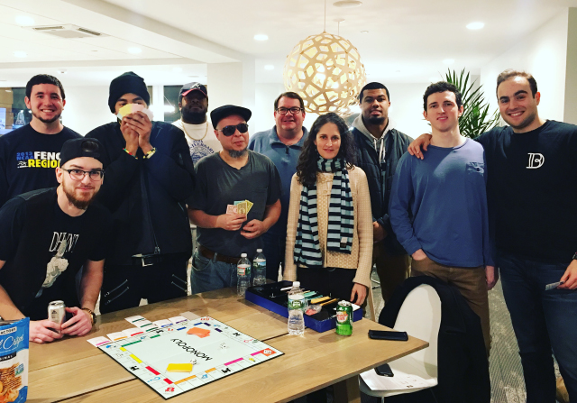 Residents gather around a board game at an early Doorbell game night in Worcester, with Ben Pleat at far right