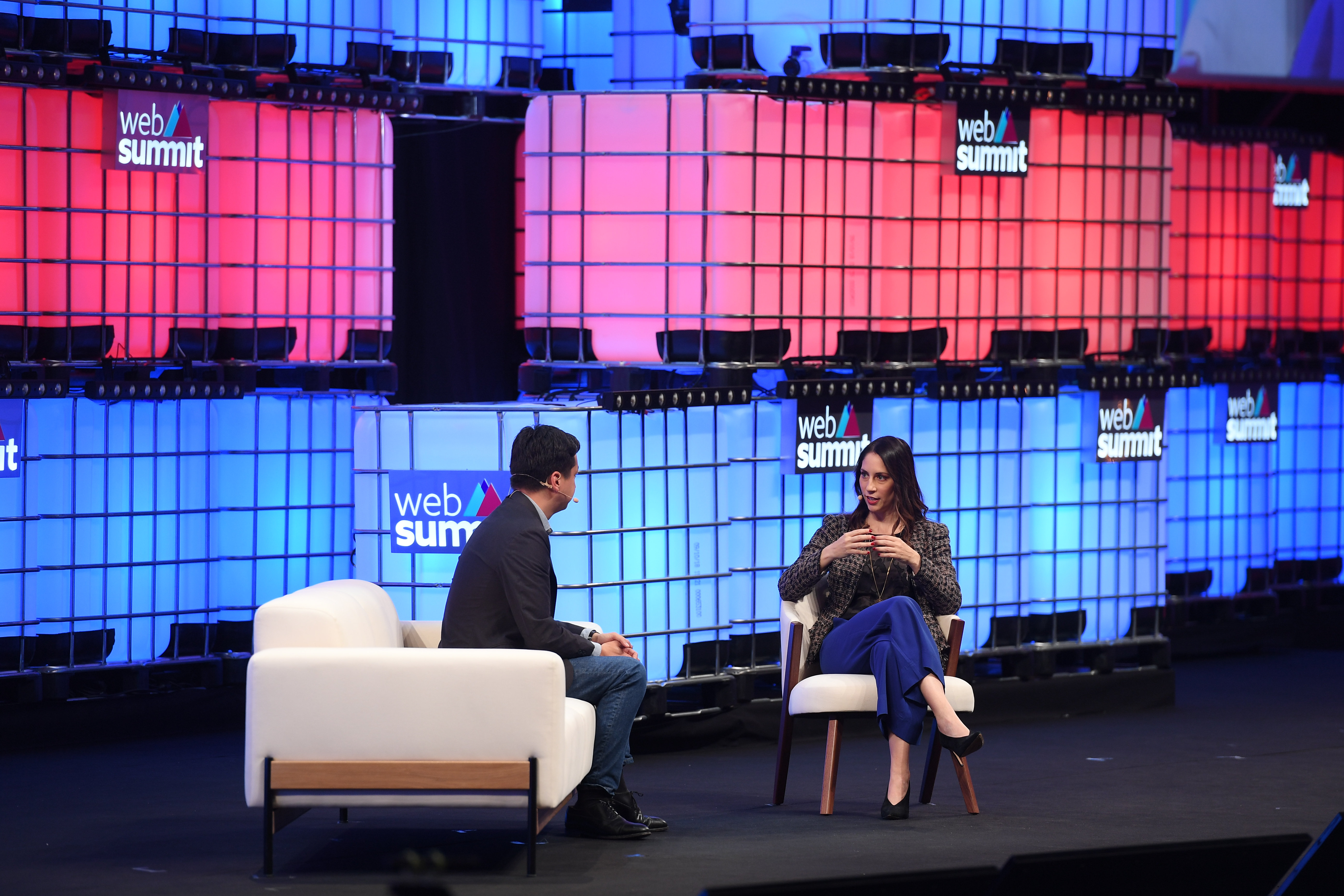 Ben Silbermann, seated at left, speaking with Lauren Goode on the brightly lit Web Summit stage in Lisbon