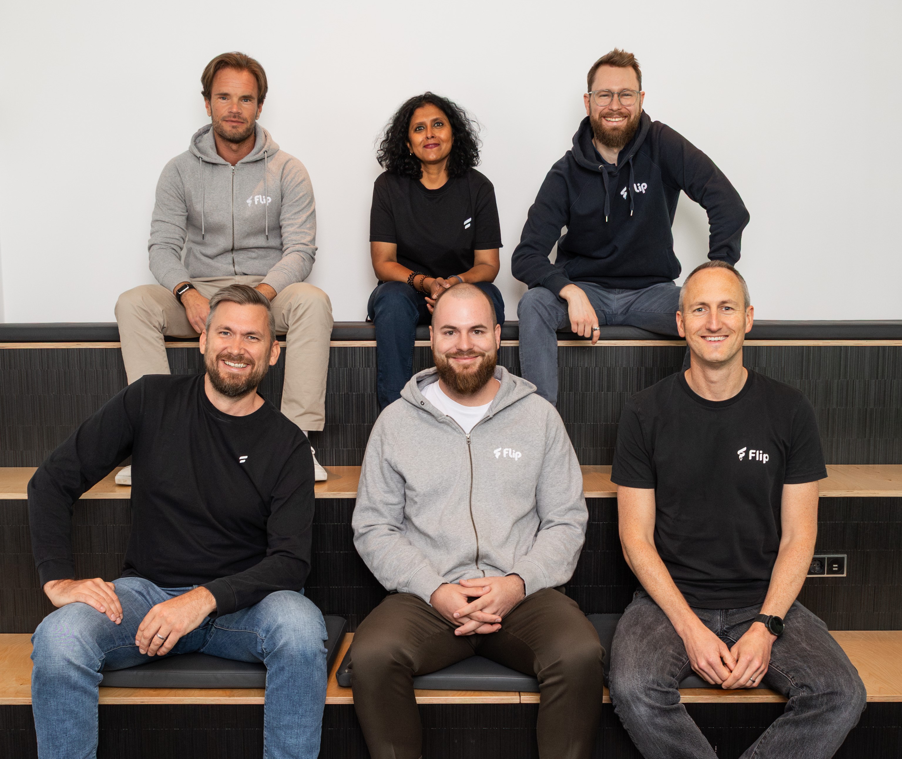 Benedikt Brand seated front centre with five colleagues from Flip’s management team