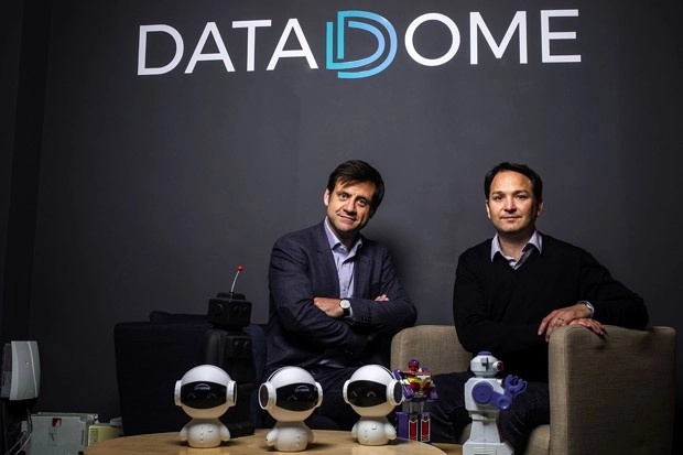 Fabien Grenier on the left and Benjamin Fabre on the right, seated behind small toy robots