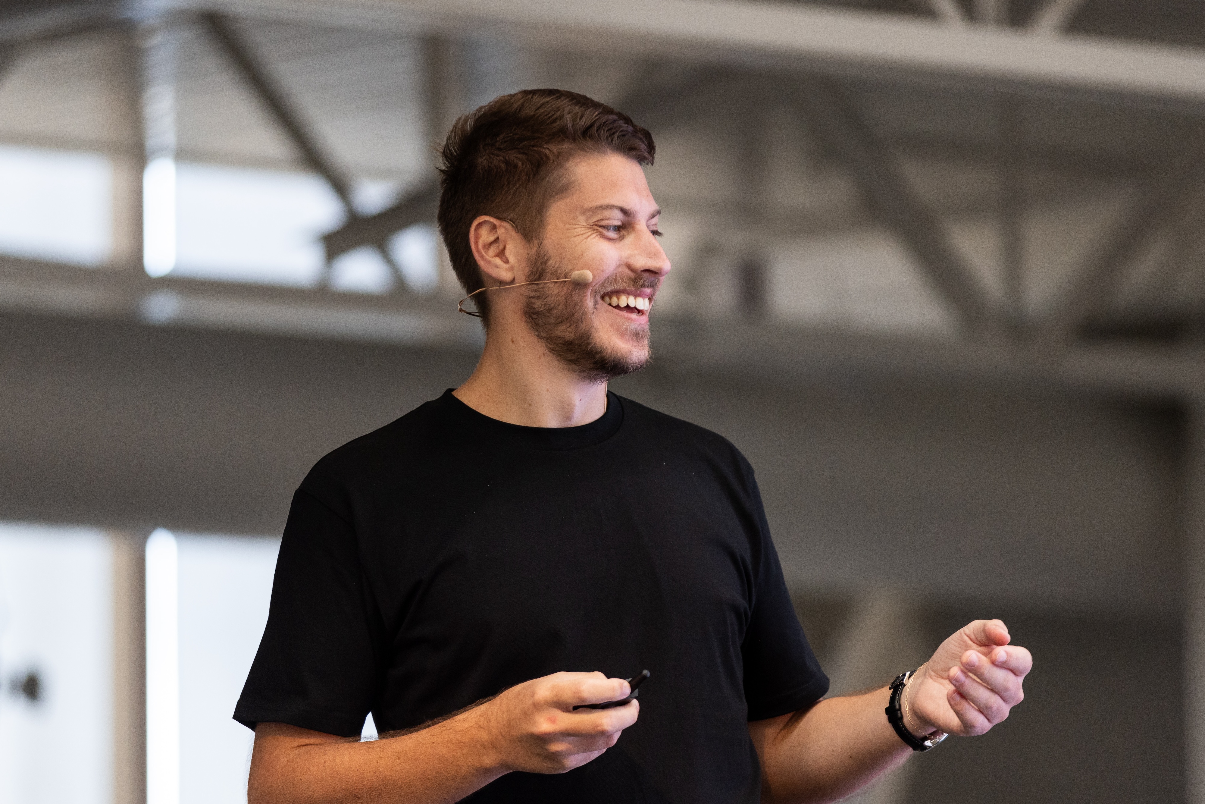 Benjamin Humphrey speaking with a headset microphone and presentation remote at Insight Out 2024