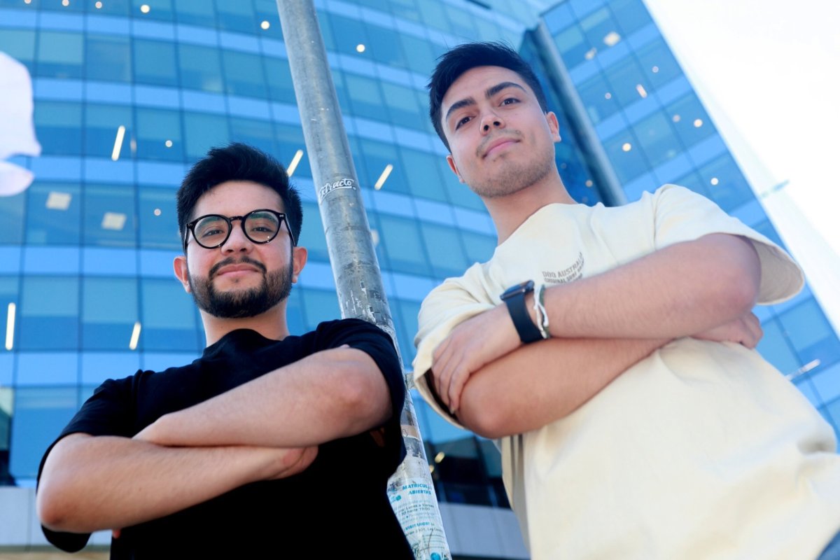 Velum Labs’ two founders standing outdoors in front of a glass building