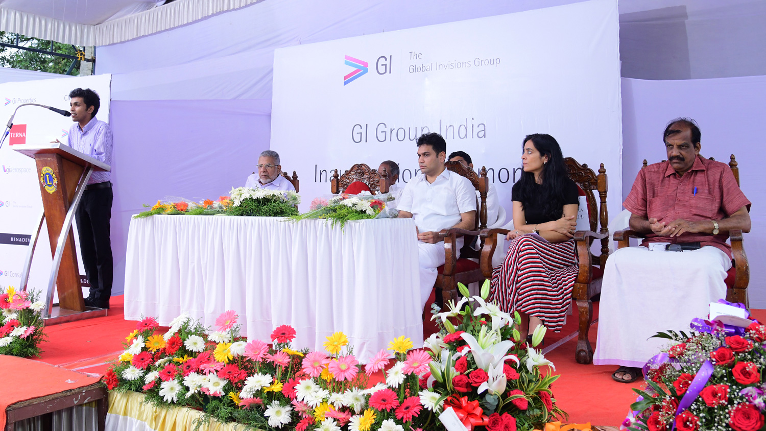 A speaker at a lectern and seated guests at GI Group India's Kochi office inauguration in 2018