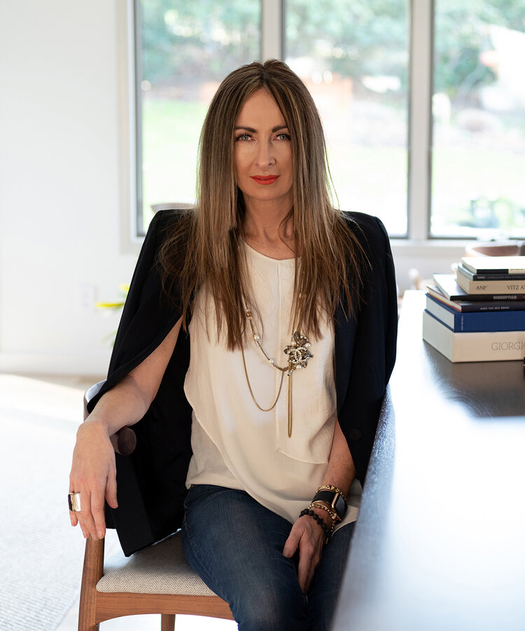Bernadette Fitzpatrick seated at a desk in a bright office
