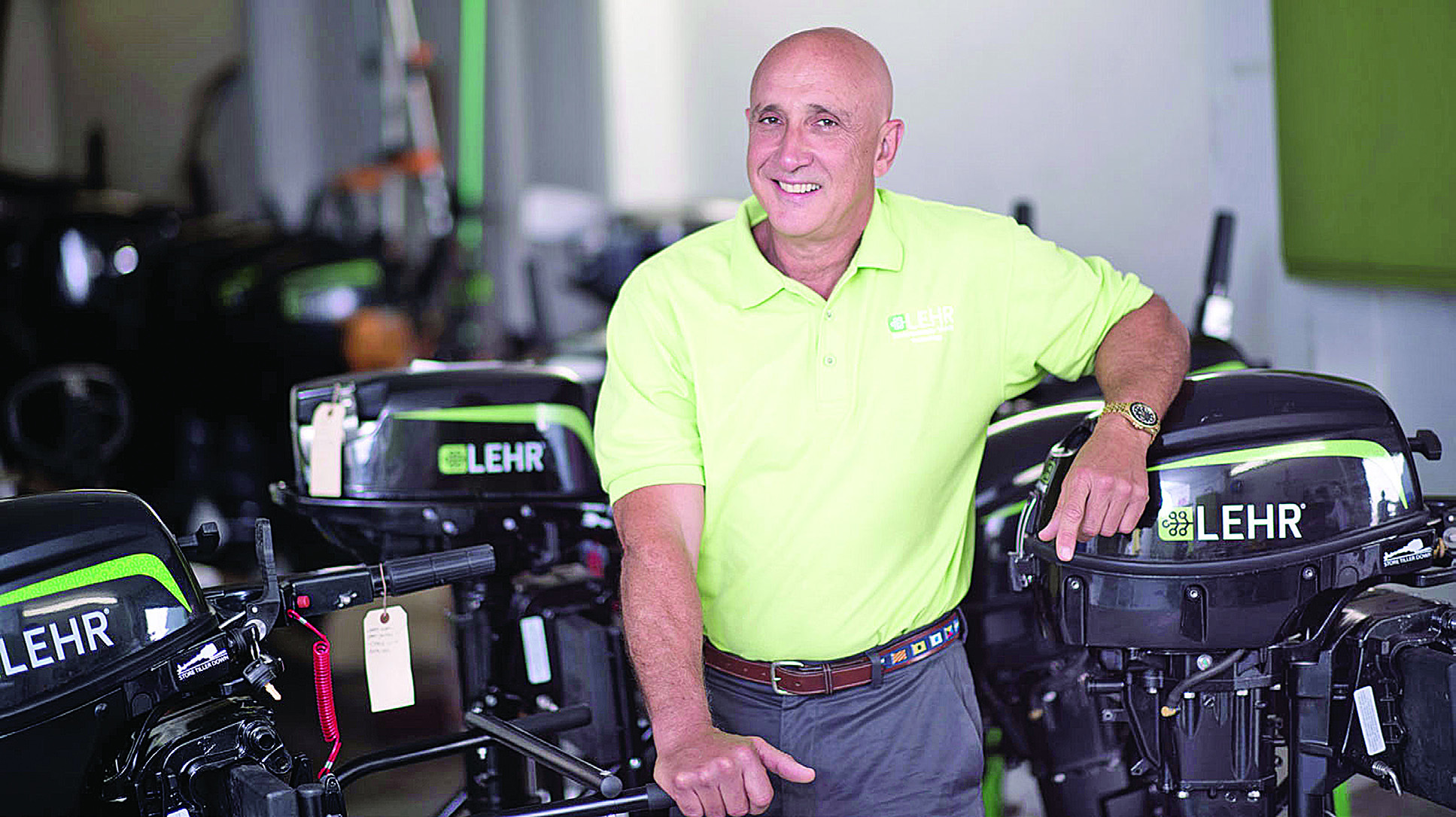 Bernardo Herzer standing among LEHR propane outboard motors