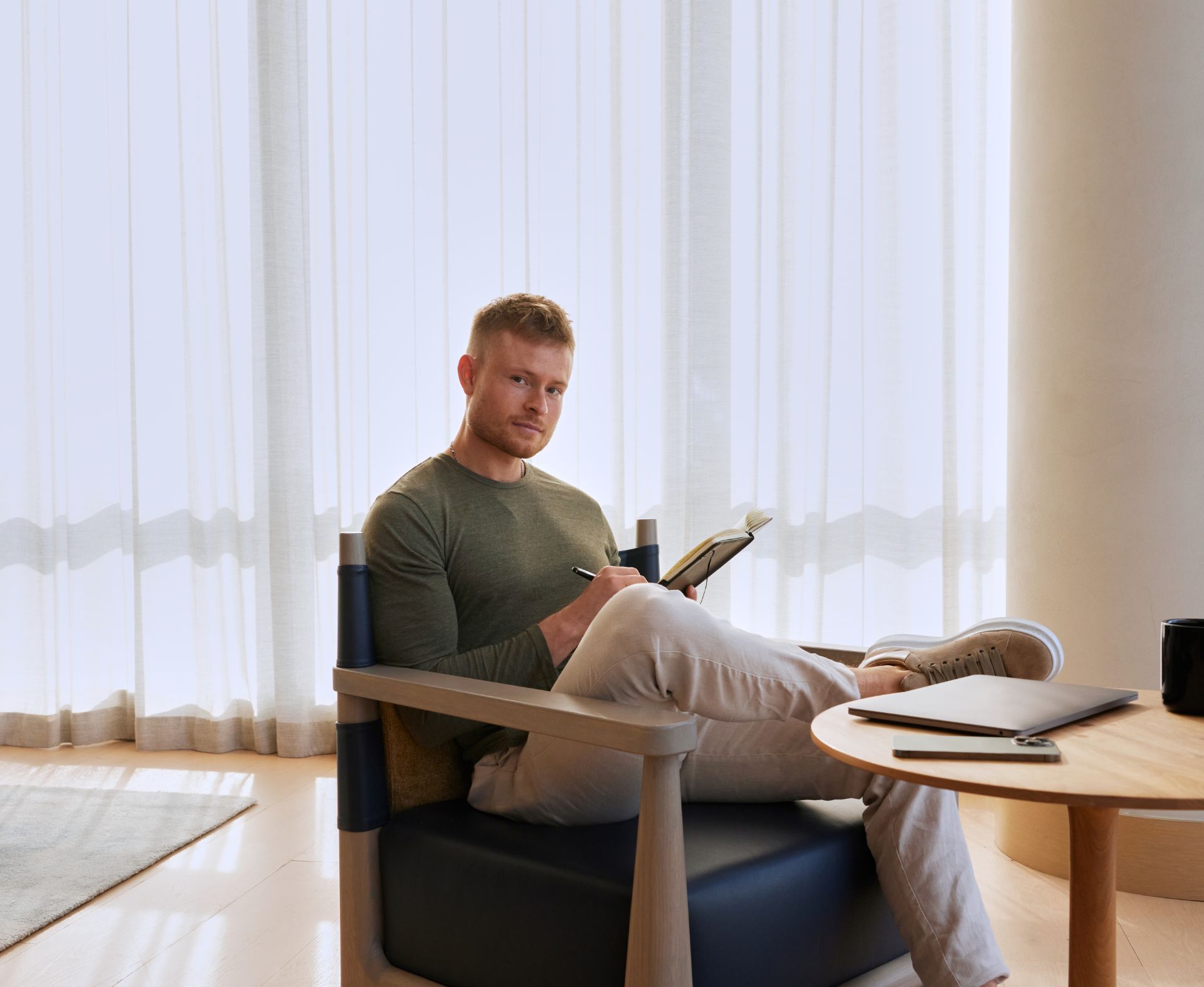 Bertram Thorslund seated with a notebook beside a laptop