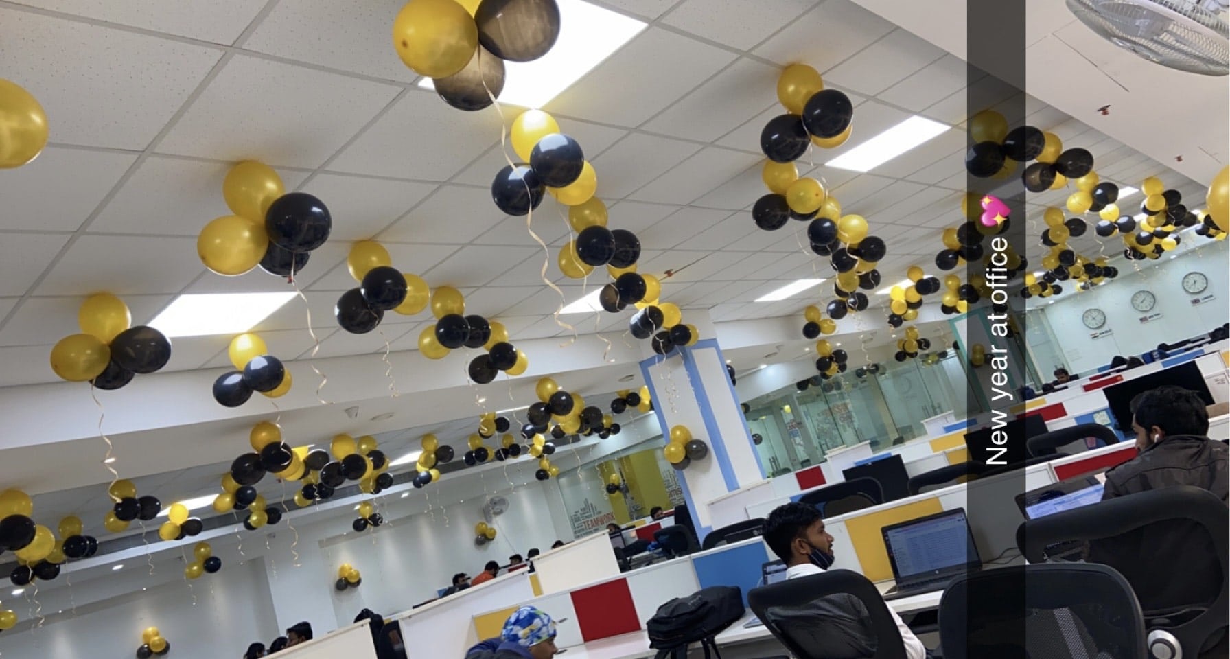 BestPeers office with black and yellow balloons above rows of desks