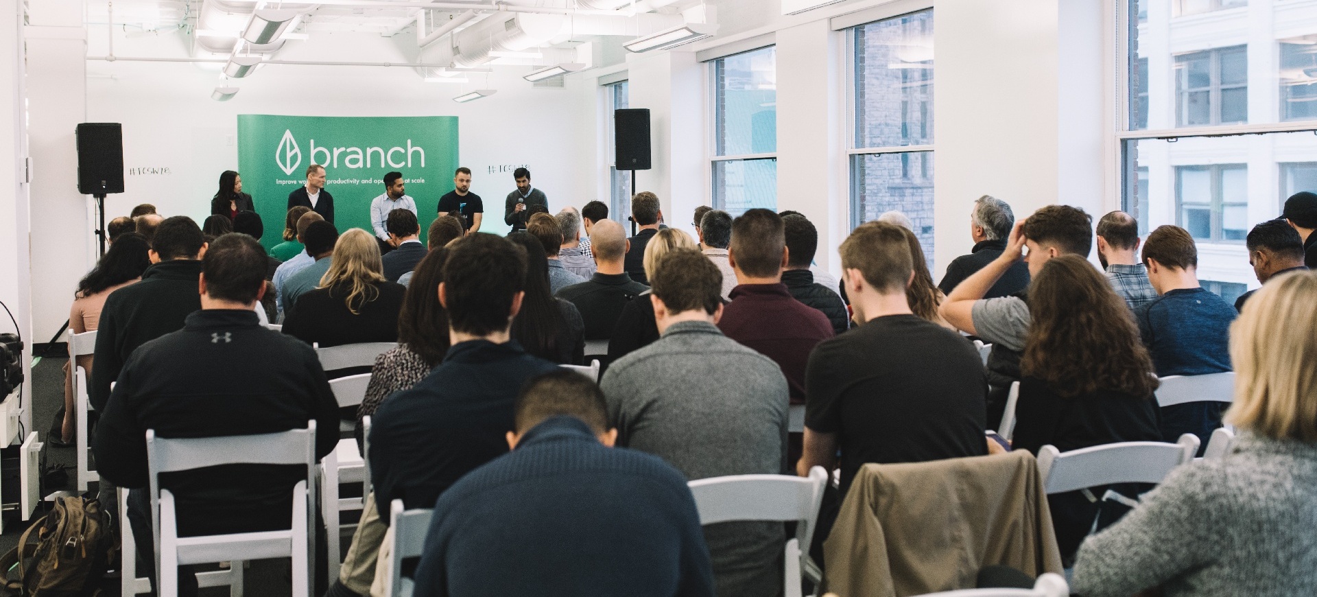An audience listening to a panel at a BETA community event