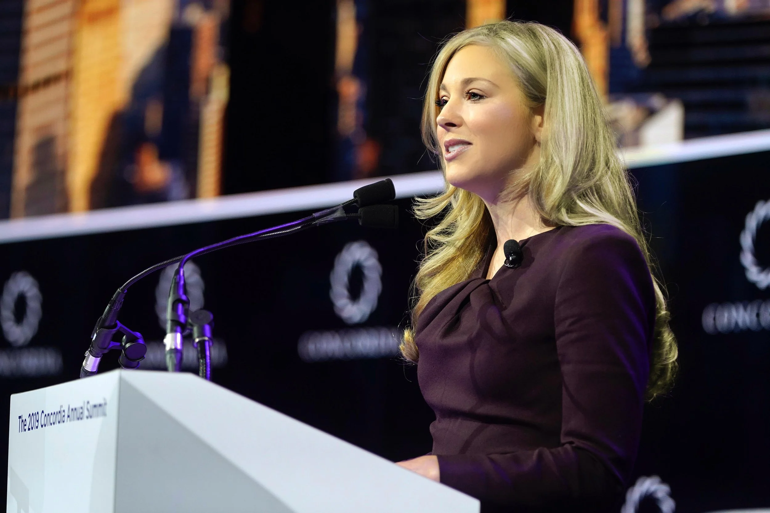 Beth Doane speaking at a lectern at the 2019 Concordia Annual Summit