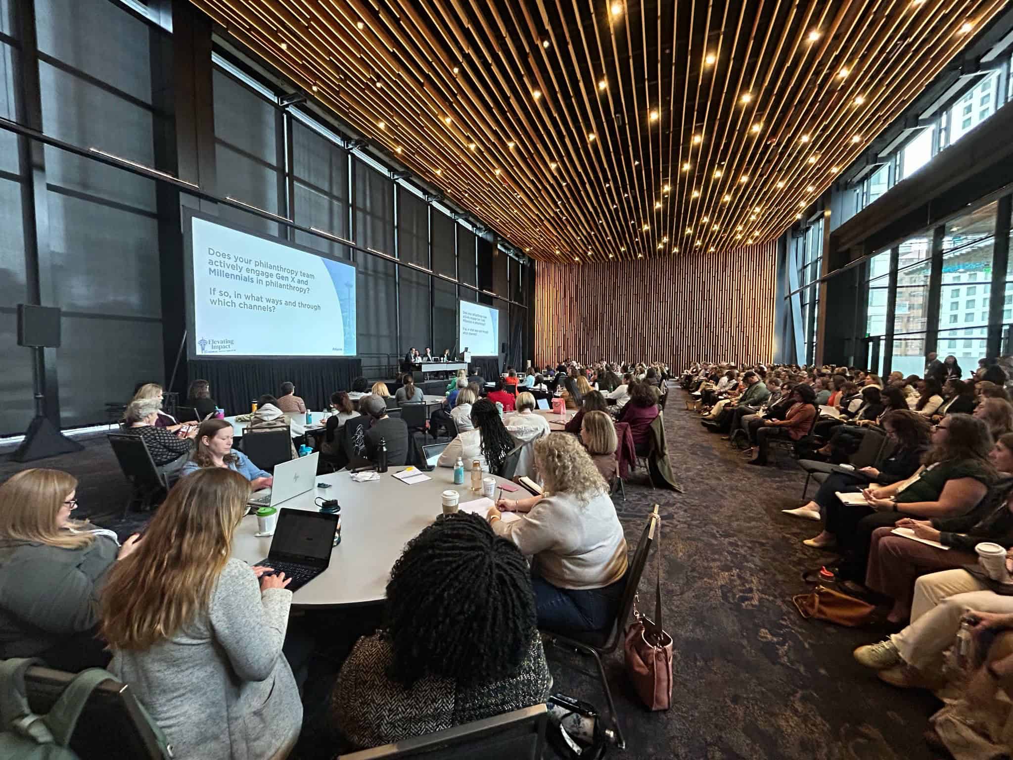 A large audience attending a philanthropy conference presentation where Beth Hatcher appeared on a generational giving panel
