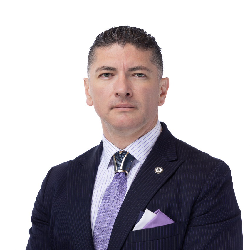 Beto Quintero in a pinstripe suit and lavender tie