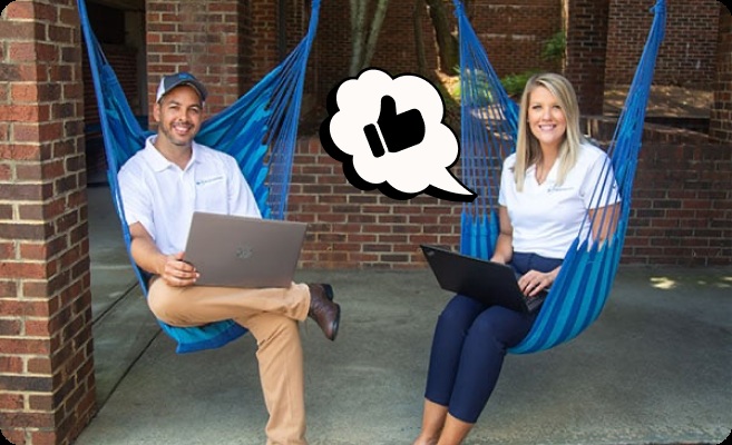 Two people using laptops in blue hanging chairs in a Better Car People careers photograph