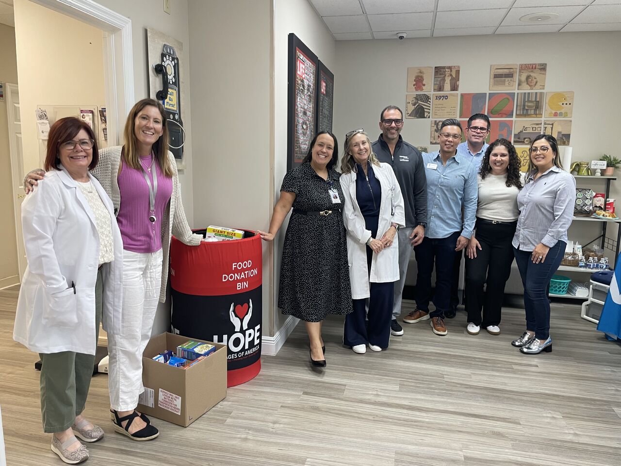 A group gathered beside food donation bins in a photograph from Better Health Group’s careers page