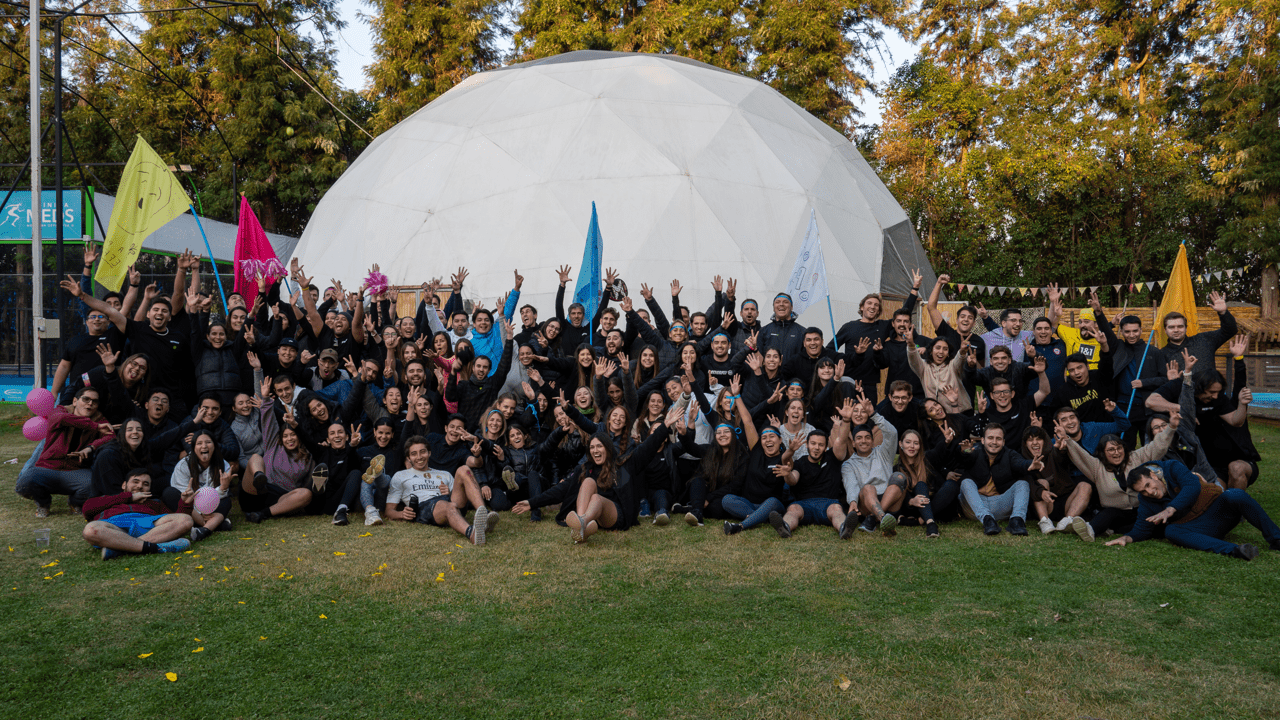 Betterfly employees gathered outdoors in front of a white event dome