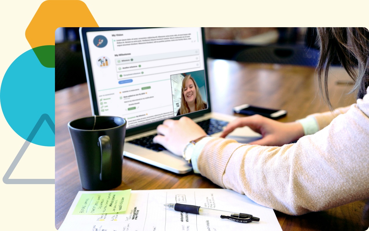 A teacher meets a coach by video beside an open notebook and a coffee mug