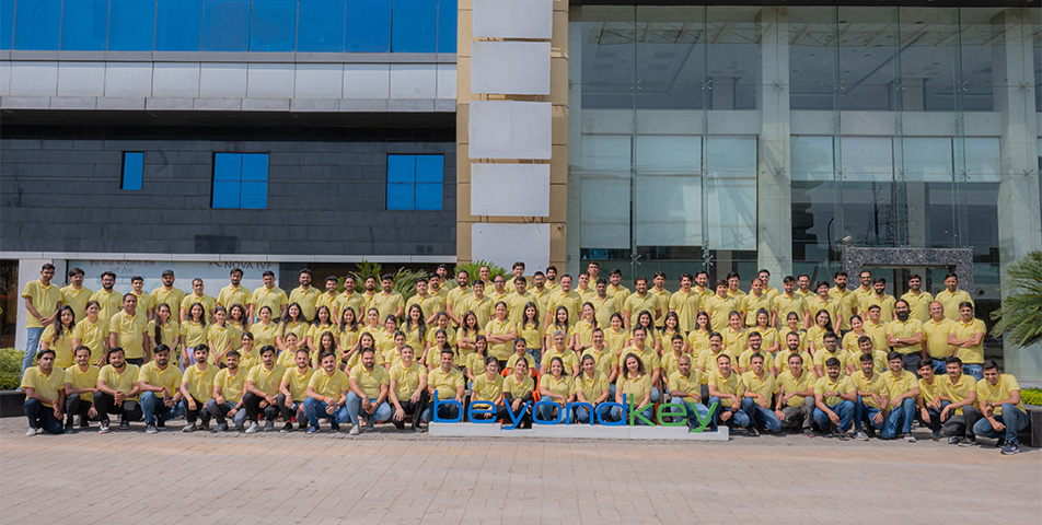 Beyond Key team members in yellow shirts gathered outside a building