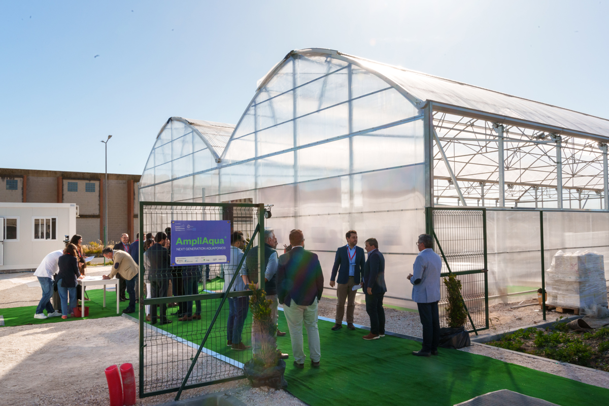 Visitors gathered outside the AmpliAqua aquaculture research greenhouse in Portugal