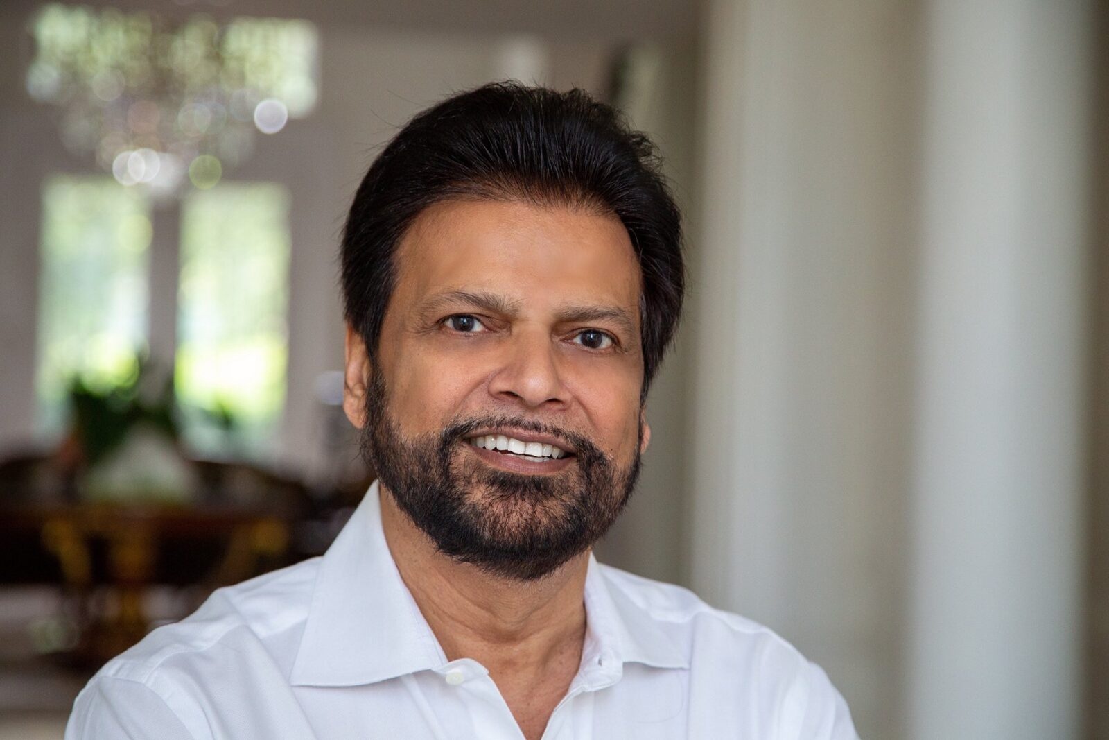 Bharat Sangani in a white shirt, photographed indoors