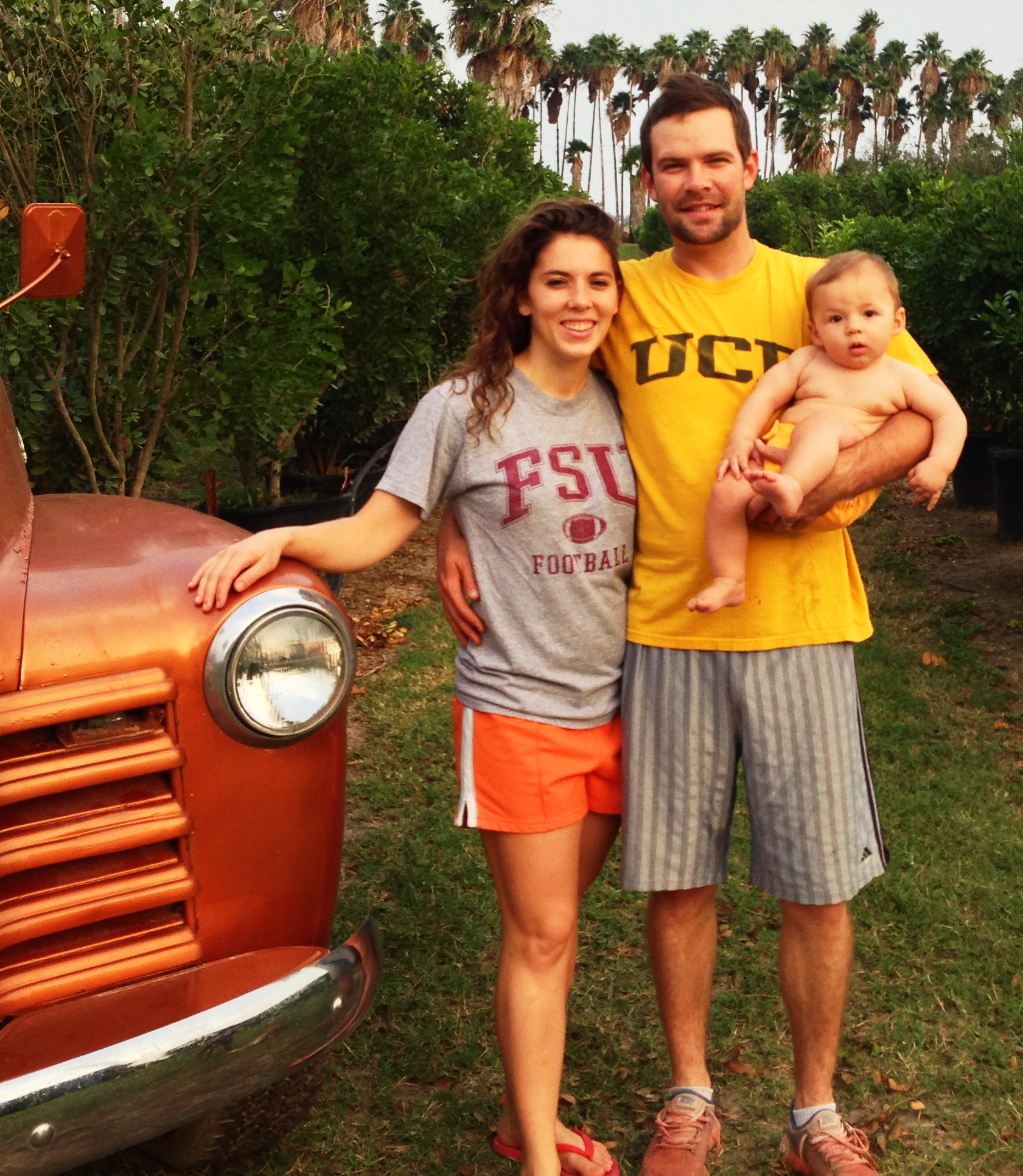 Bibb Beale with his family beside an orange vintage vehicle, in an archival photograph published by HCD Auto Body