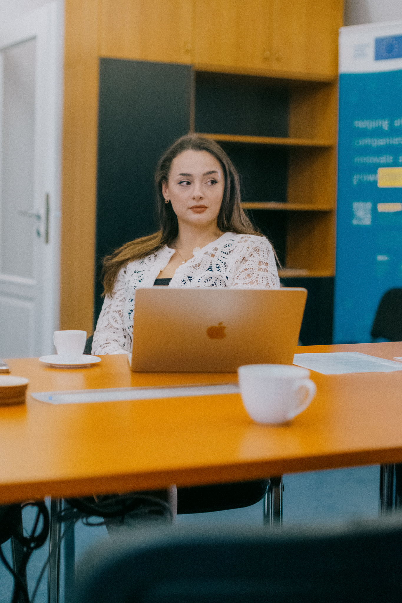 A participant at a table with a laptop during a BIC incubation meeting