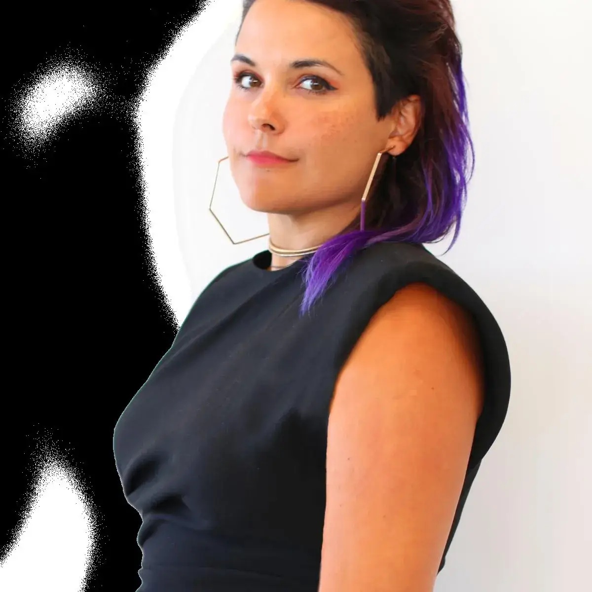 Big Smile Co. founder Maria Consuelo Gónima with purple-tipped hair and geometric earrings