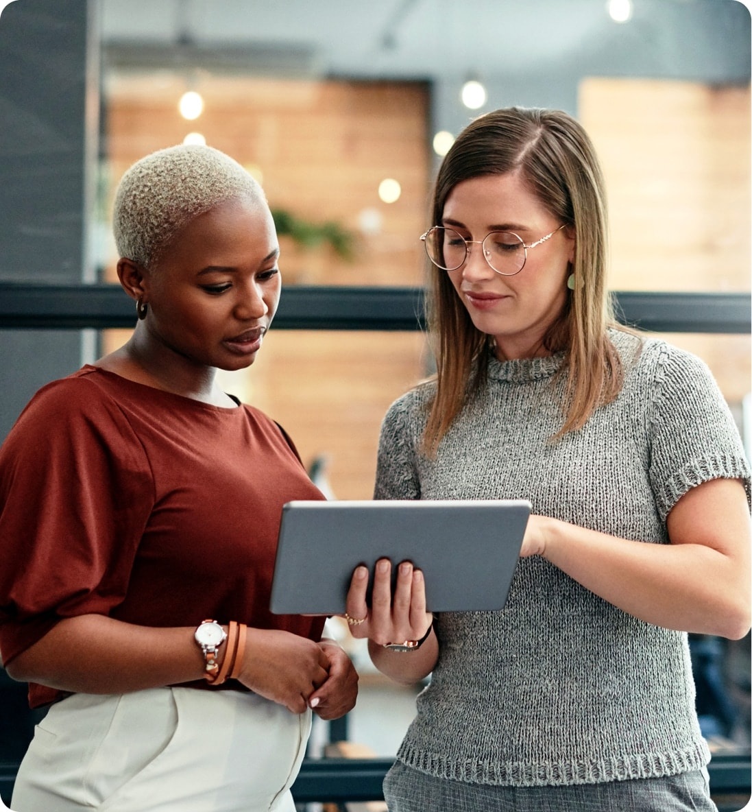 Two people reviewing information together on a tablet