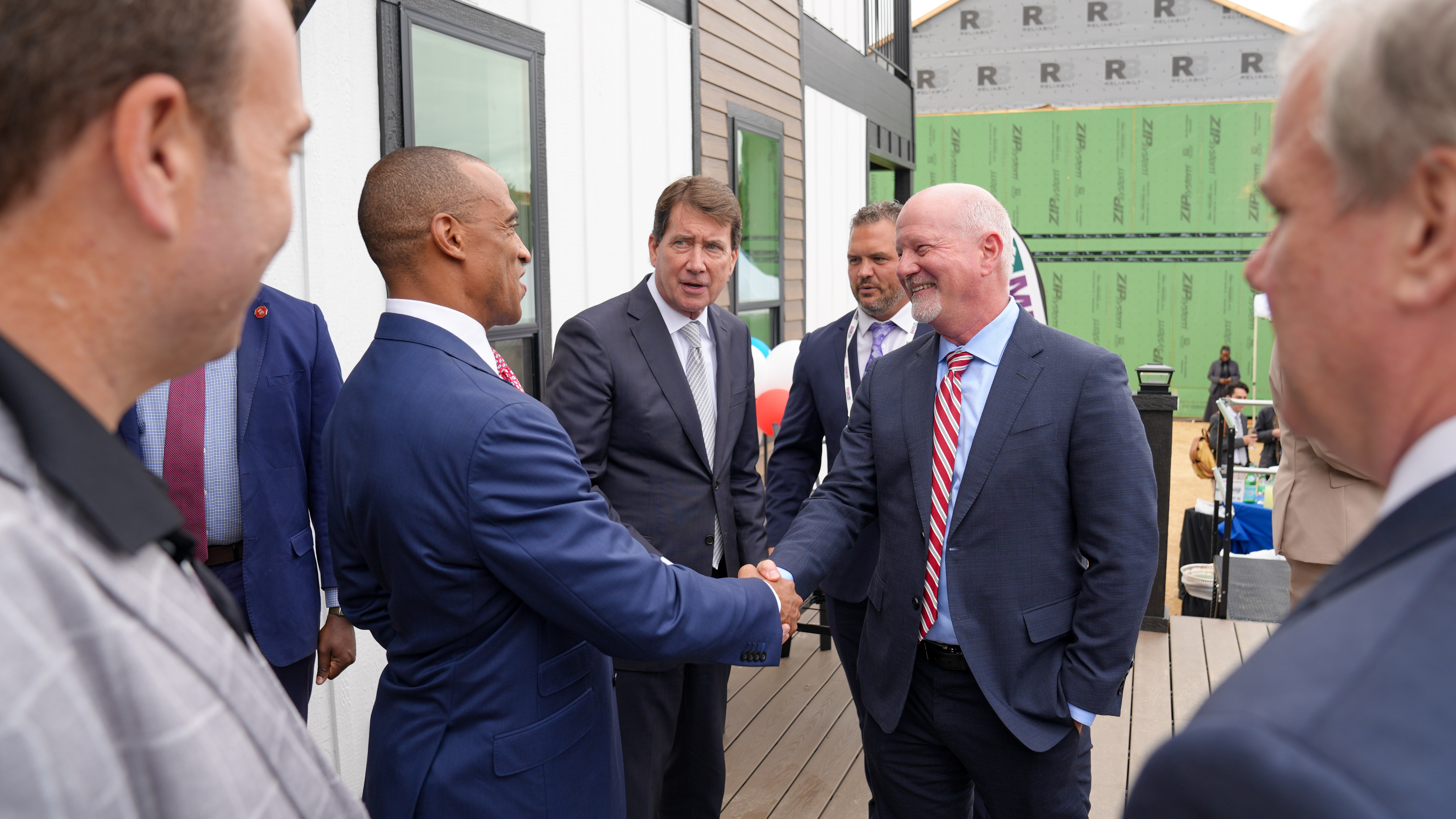 HUD Secretary Scott Turner shaking hands with Bill Boor at the 2026 Innovative Housing Showcase.