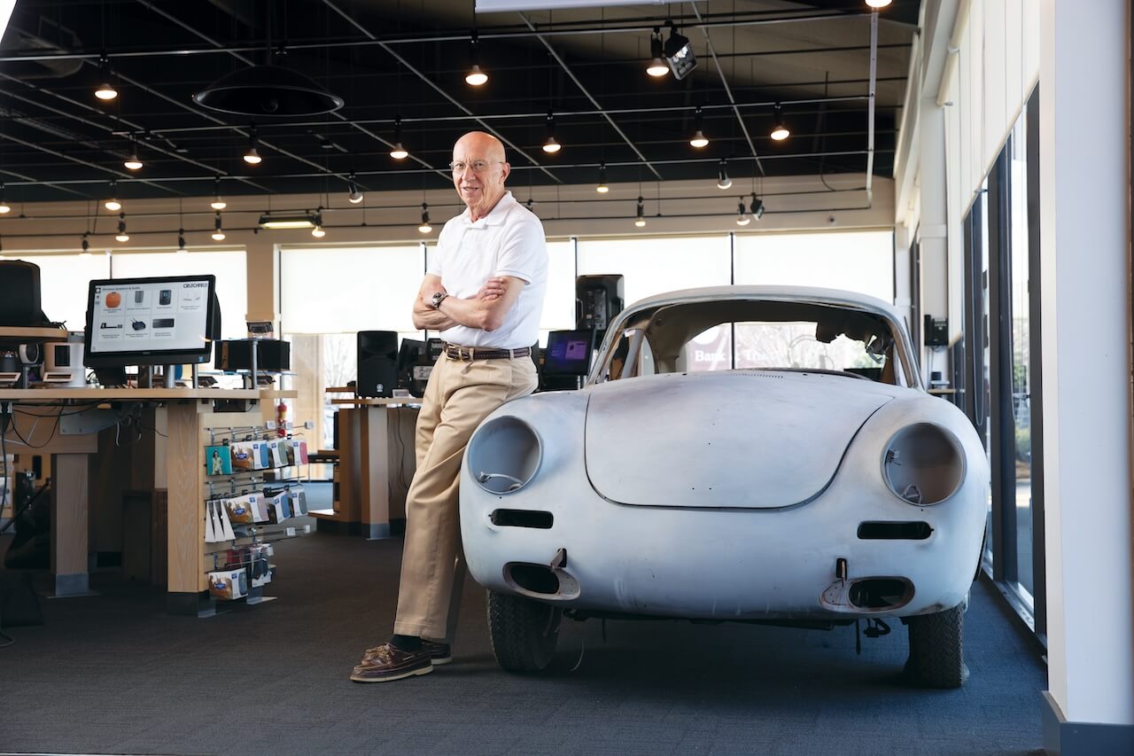 Bill Crutchfield beside the Porsche 356 in the Charlottesville showroom
