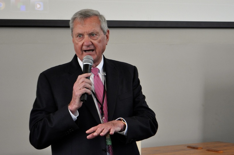 Bill Greehey speaking into a handheld microphone at a Haven for Hope event